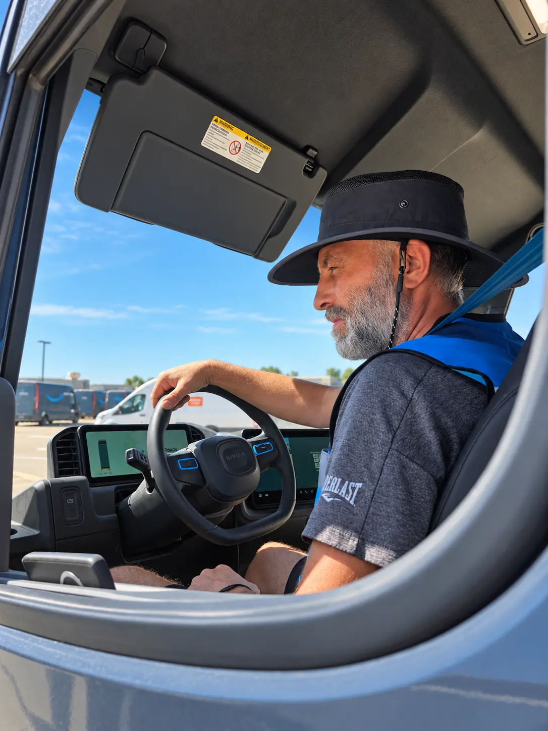 Experienced delivery associate inside a Rivian van