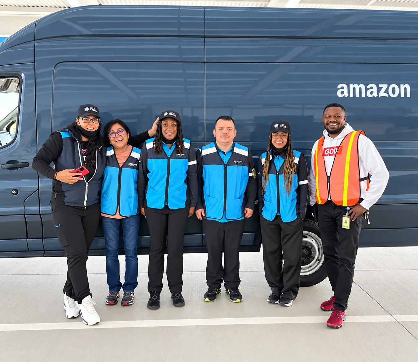 Micaramy team members standing beside a delivery van